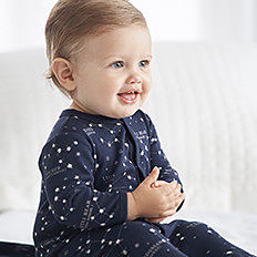 RALPH LAUREN CHILDREN’S CLOTH a baby boy wearing a navy onesie with white dots. shop baby boys TALJCWR