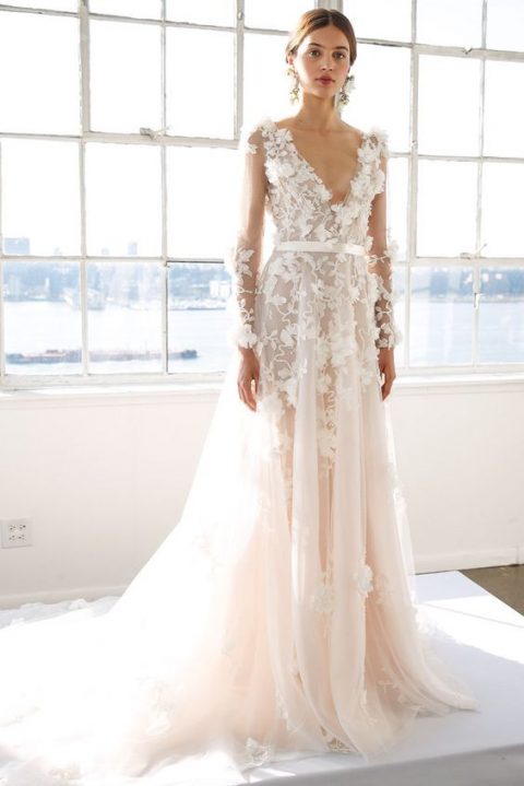 a feminine floral lace applique wedding dress with long sleeves and a  plunging neckline